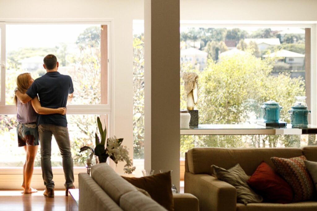man standing in sunny living room.